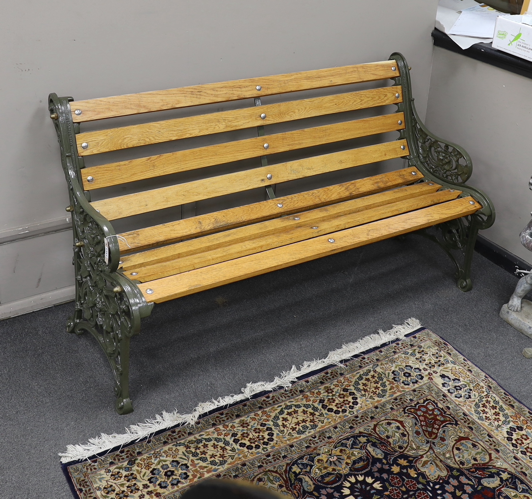 A Victorian Coalbrookdale 'nasturtium' pattern cast iron garden bench restored with later oak slats, length 146cm, depth 64cm, height 81cm